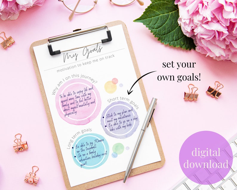 May include: A printable worksheet with a pink background and a brown clipboard. The worksheet is titled "My Goals" and includes sections for "Why am I on this journey?", "Long term goals", and "Short term goals". The worksheet is designed to help people set and achieve their goals.