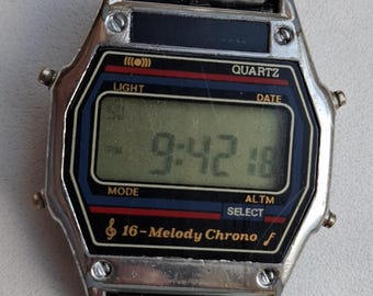Vintage 16 Melody Chrono Digital Watch 80s Retro LCD Watch USA Eagle Emblem Stretch Bracelet Melody Alarm Quartz Watch