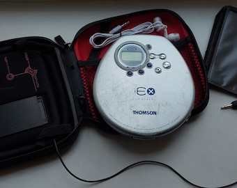 May include: A silver and black portable CD player with a digital display and a carrying case. The player has the text "Thomson" and "eXperience" on it.