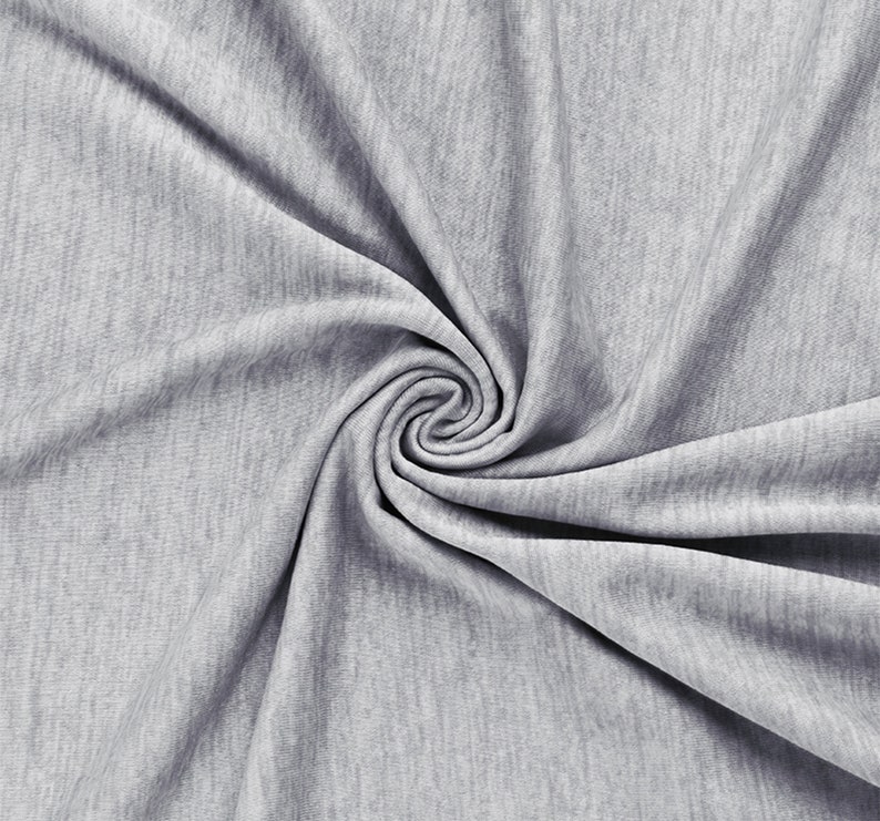 May include: A light gray heathered fabric with a soft, fine-knit texture. The material is gathered into a central spiral swirl, creating deep, flowing folds and shadows that highlight the consistent, mottled color pattern across the surface.