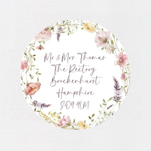 May include: A white circle with a floral wreath border. The text inside the circle reads "Mr & Mrs Thomas The Rectory Brockenhurst Hampshire SO42 9UM".