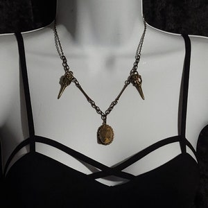 Tumbled Stone Antique-Look Pendant featuring Raven Skull Detail