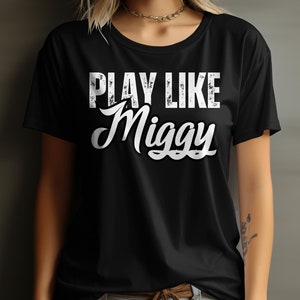 May include: Black t-shirt with white text that reads "PLAY LIKE Miggy".