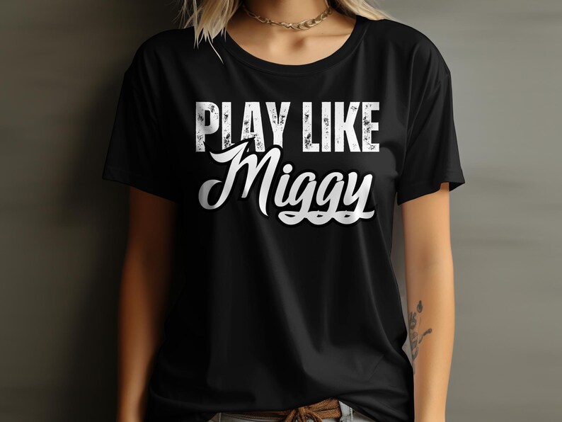 May include: Black t-shirt with white text that reads "PLAY LIKE Miggy".