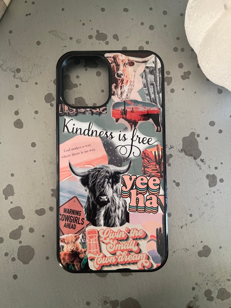 May include: A black phone case with a collage of images and text. The text includes "Kindness is free", "God makes a way where there is no way", "WARNING COWGIRLS AHEAD", "yee haw", and "Livin' the Small Town Dream".