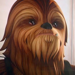 May include: A close-up of Chewbacca's face, showing his brown fur, dark eyes, and a small white tooth.
