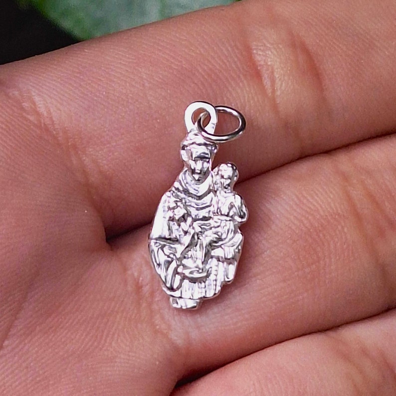 St. Anthony pendant placed on an open hand