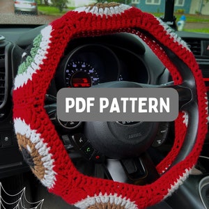 May include: Crochet steering wheel cover with a red, white, and brown color scheme. The cover features a repeating eye pattern. The text "PDF PATTERN" is displayed on the image.