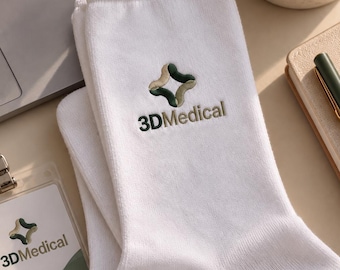 May include: A pair of white crew socks featuring an embroidered logo with a four-pointed star shape in shades of olive green and beige, accompanied by the text 3DMedical in dark green lettering centered on the upper portion of the socks.