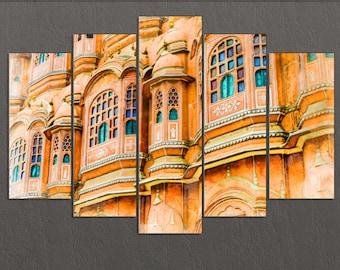 May include: A multi-panel wall art print featuring a close-up of a colorful, ornate building with intricate details and arched windows. The building is painted in shades of orange, yellow, and white.
