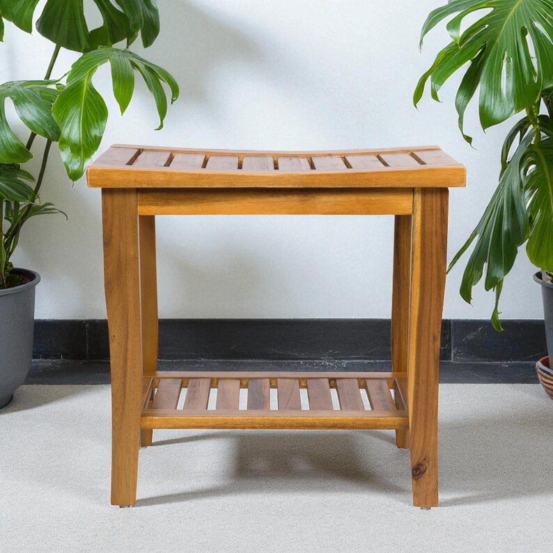 May include: A wooden bench with a slatted seat and a lower shelf. The bench is made of light brown wood and has a rectangular shape. The bench is surrounded by green plants.