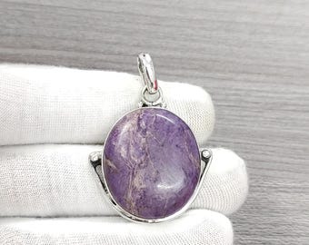 May include: A silver pendant with a purple and white oval gemstone. The pendant has a simple design with a silver bail.