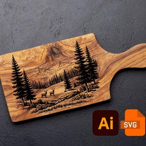 May include: Wooden cutting board with a handle, featuring a detailed laser-etched forest scene with deer and pine trees. The board has a natural wood grain and a smooth finish. The design includes mountains and trees. The board is approximately 12 inches long.