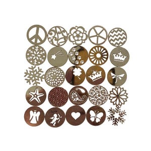 May include: Set of 20 silver metal decorative charms with various designs, including snowflakes, stars, hearts, crowns, and butterflies.