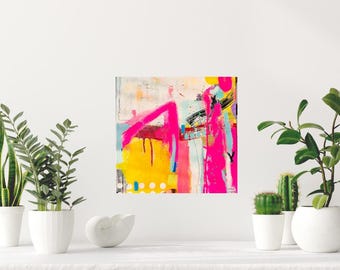 May include: Abstract art piece with a vibrant mix of colors. The artwork features bold strokes of hot pink, yellow, and black against a white and light blue background. The painting is displayed on a white surface with potted plants.