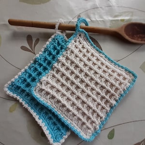 Un par de agarraderas tejidas a crochet con punto gofre