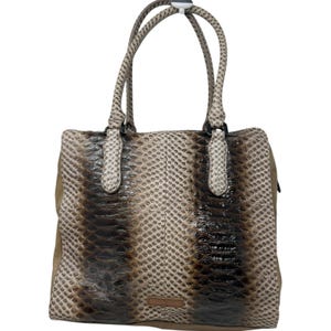May include: A structured handbag featuring a snakeskin-patterned exterior in shades of brown, tan, and cream. The bag includes two matching top handles, a rectangular body with a central vertical seam, and a small rectangular brand tag at the base.