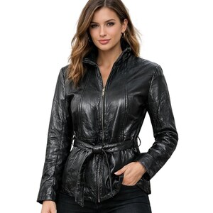 May include: A black jacket with a textured finish, featuring a full-length front zipper, a high collar, long sleeves, and a matching tie belt at the waist. The garment has vertical seam detailing along the front and is constructed from a material with a subtle sheen.