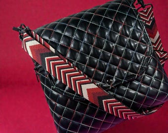 Messenger bag, magnetic snap closure. Beautifully quilted faux leather with multi colored thread. Guitar strap.