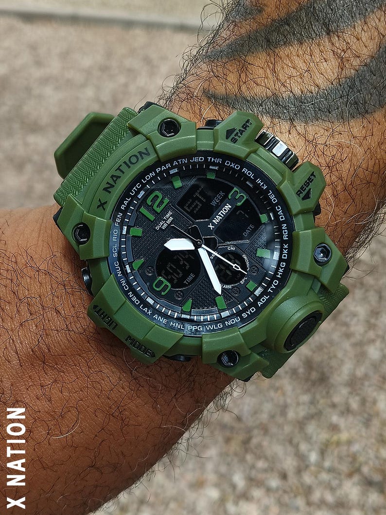 May include: Green digital watch with the text "X NATION" on the band and face. The watch face displays the time, date, and other functions. The watch has a black and green face with white hands and numbers.
