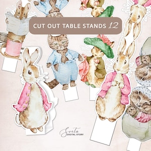 Puede incluir: Ilustraciones en acuarela de varios personajes de animales, incluyendo un conejo, un gato y un ratón, diseñados como soportes de mesa recortados. Los personajes visten ropa colorida. El texto "CUT OUT TABLE STANDS 12" se muestra en una pancarta marrón.