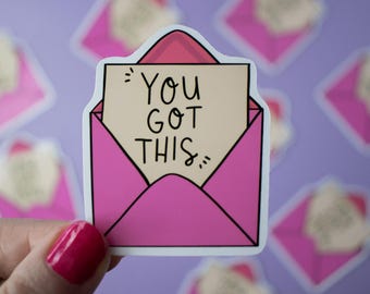 May include: Pink envelope sticker with the text "You got this" in black lettering. The sticker is designed to look like a handwritten note.
