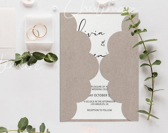 May include: A brown wedding invitation with a scalloped edge and the text "Divia & Ben" in black calligraphy. The invitation includes the date "October 1" and the time "4 o'clock in the afternoon".