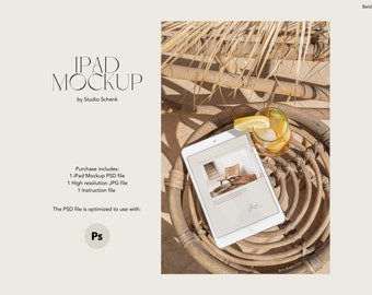 May include: A white iPad mockup with a website displayed on the screen. The iPad is sitting on a woven wicker chair with a glass of iced tea and a lemon wedge on the side.