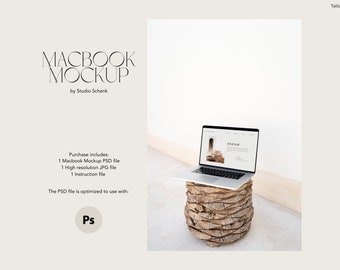 May include: A silver laptop computer with a white background on the screen is sitting on a wooden stump. The laptop is open and the screen is displaying a website with the text "SHOP NOW". The text "MACBOOK MOCKUP" is displayed above the laptop.