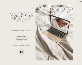 May include: A gold laptop computer with a white screen displaying a website with the text "Beauty Grown" on a white bedspread. The PSD file is optimized to use with Photoshop.