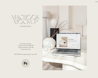 May include: A white table with a laptop computer open to a website with the text "SHOP NOW". The laptop is on a white table with a vase of dried branches and a glass of water. The text "MACBOOK MOCKUP by Studio Schenk" is at the top of the image.