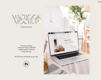 May include: A silver laptop computer with a white screen displaying a website with the text "SHOP NOW". The laptop is on a wooden table with a glass of iced tea in the foreground.