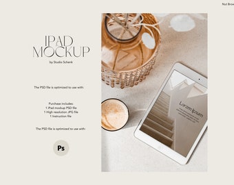 May include: A white iPad mockup with a photo of a staircase on the screen. The text "Lorem Ipsum" is displayed on the screen. The iPad is on a light brown surface with a cup of coffee and a decorative vase with white flowers.