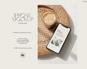 May include: A mockup of an iPhone on a woven tray with a cup of coffee. The phone screen displays a website with the text "We're offering a new service."