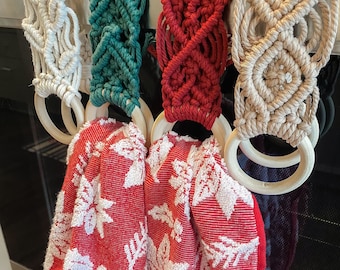 May include: Four crocheted pot holders with wooden rings. The pot holders are in various colors and patterns, including beige, green, red, and white.
