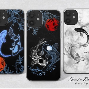 May include: Three phone cases with different designs featuring black and white koi fish, a red and black koi fish, and a yin yang symbol with koi fish. The cases are all clear and have a black border.