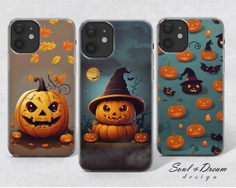 May include: Three phone cases with a Halloween theme. The cases are clear and show a design of pumpkins and bats. The text "Soul + Dream design" is on the bottom of the case.