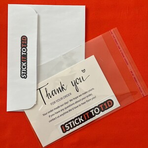 May include: A white envelope with a black sticker that says "STICK IT TO T1D" and a white card with the text "Thank you" and "FOR YOUR ORDER" and "Your order made our day! We hope we make yours. If you have any questions about your order, contact us anytime. We'd love to hear from you!" and a black sticker that says "ISTICK IT TO T1D".