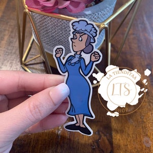 May include: A blue and white cartoon sticker of a woman with a stern expression, with her arms raised in the air. The sticker is on a white background and has the text "La Tienditaa LTS Shop" in a circle around it.