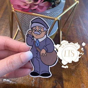 May include: A cartoon sticker of a mail carrier wearing a blue uniform and a brown bag. The sticker is on a white background and has the text "La Tiendita LTS Shop" in a circle around it.