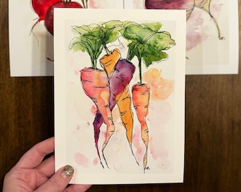 May include: Watercolor painting of three carrots with green tops. The carrots are painted in shades of orange, purple, and yellow. The background is a soft pink watercolor wash.