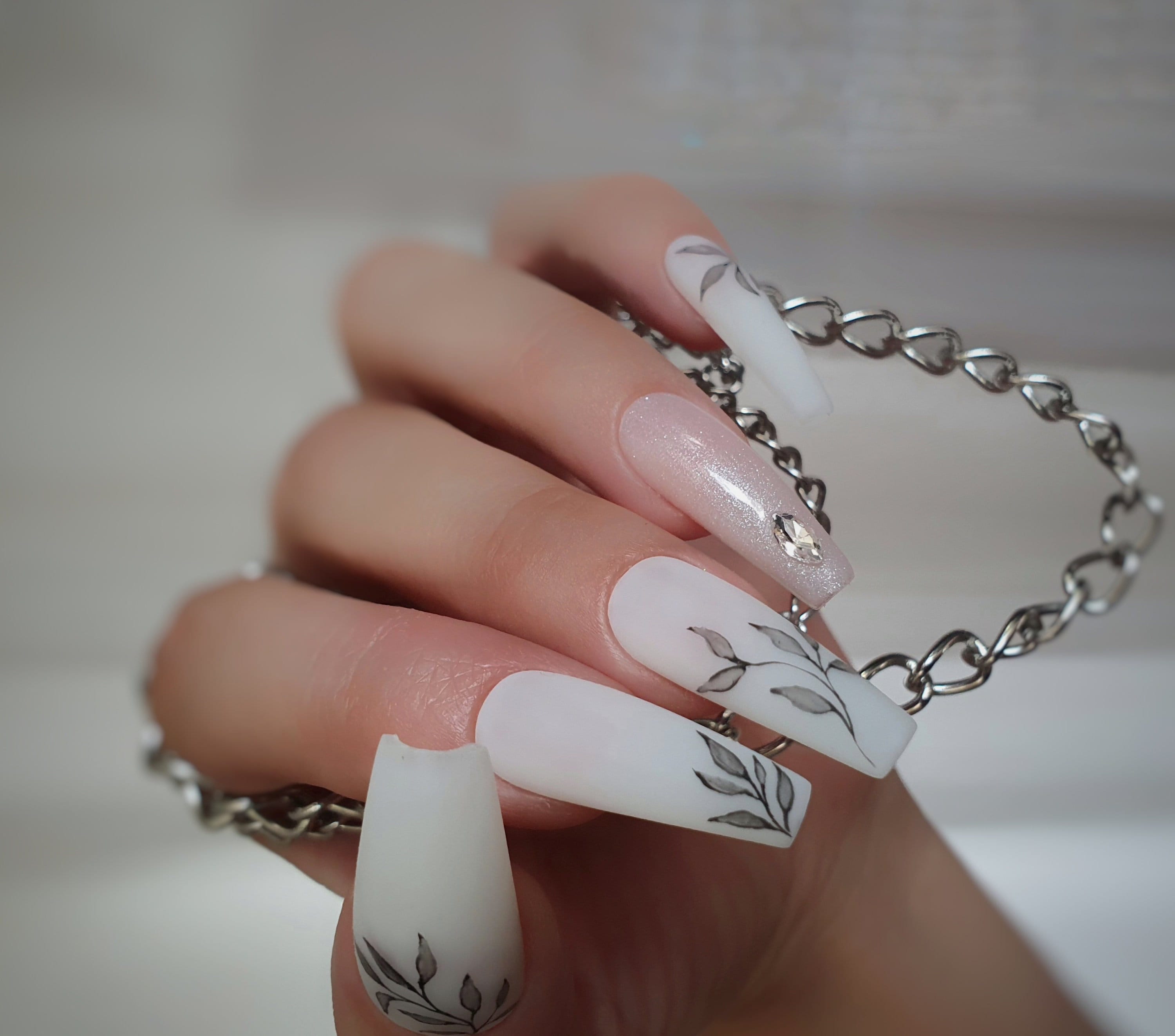 white nails with silver design