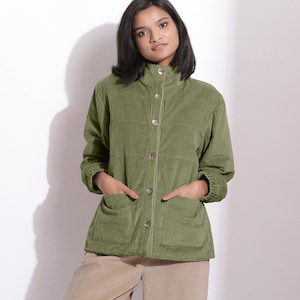 May include: A green corduroy jacket with a button-up front and two pockets. The jacket has a stand-up collar and long sleeves.