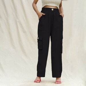 May include: Black cargo pants with multiple pockets and a gold button closure.