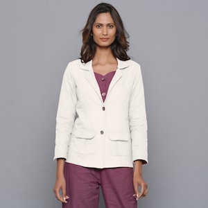 May include: A white linen blazer with a notched collar, two front pockets, and a button closure. The blazer has a relaxed fit and is perfect for layering.