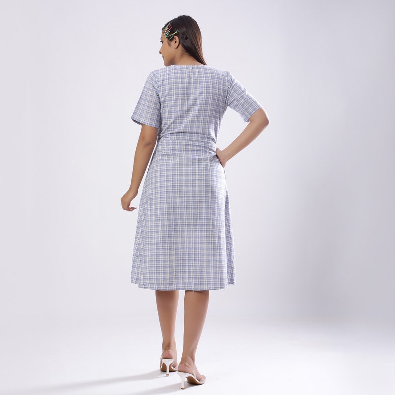 May include: A blue and white plaid dress with a short sleeve and a knee-length skirt.