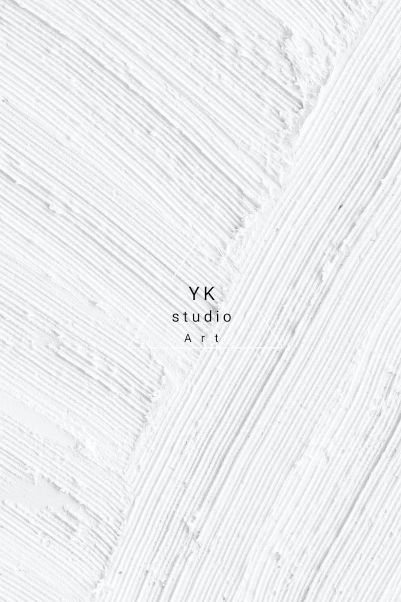 May include: White textured art piece with diagonal brushstrokes. The image features the text "YK studio Art" in a minimalist design, suitable for wall decor or artistic prints.