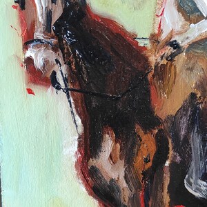 May include: Oil painting of a cowboy on a horse, rendered with thick brushstrokes. The horse is primarily brown and black, with a white face. The background is a light green with a hint of red and yellow at the bottom.