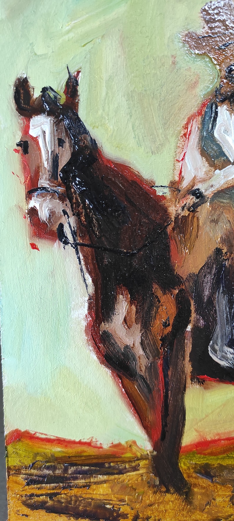 May include: Oil painting of a cowboy on a horse, rendered with thick brushstrokes. The horse is primarily brown and black, with a white face. The background is a light green with a hint of red and yellow at the bottom.