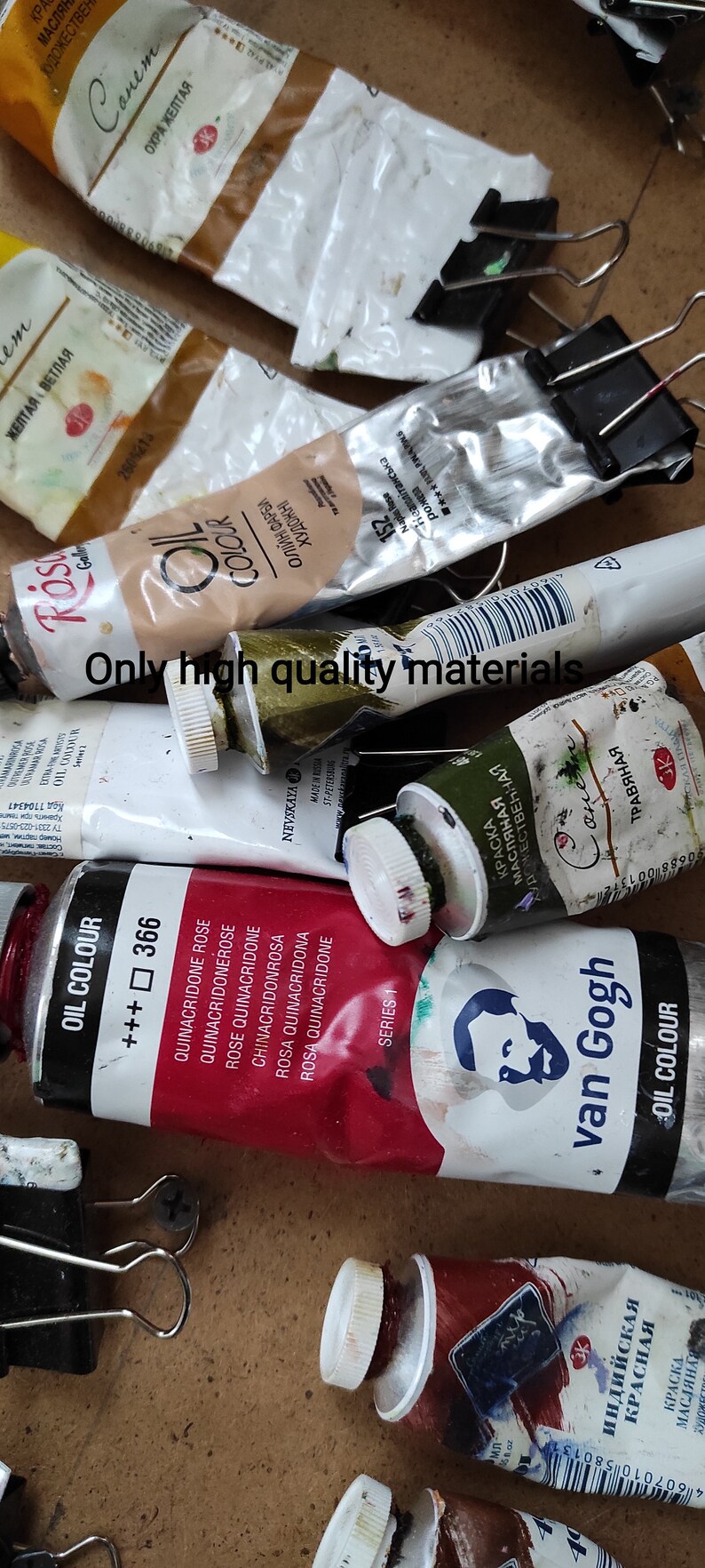 May include: A collection of oil paint tubes in various colors, including red, yellow, and brown, some with text in a foreign language. The tubes are partially squeezed and show signs of use, with some held together by binder clips. The text "Only high quality materials" is visible.
